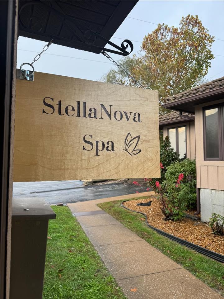 The wooden StellaNova Spa sign outside the Festus spa